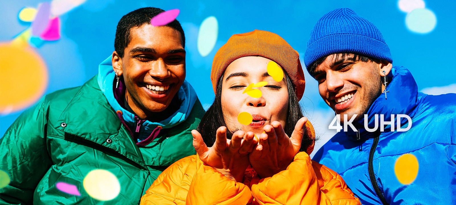 Three people wearing green, yellow, and blue outfits.