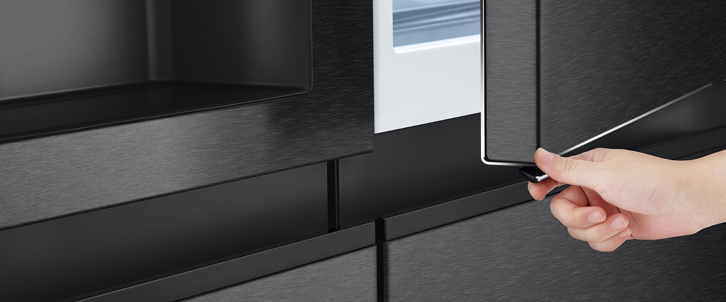 Someone is opening the door of refrigerator using the Door-in-Door™ button