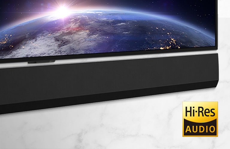 A mid-shot of the the right side of the LG Soundbar. The TV shows an image of space.