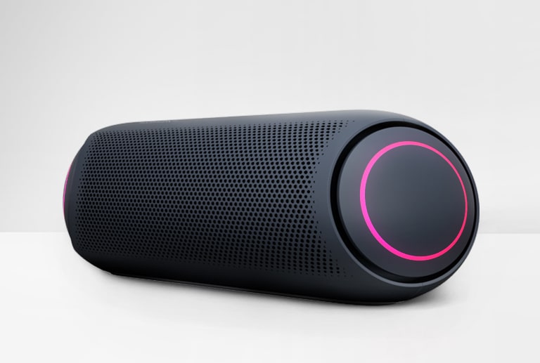 On a white background, there is an angled view of LG XBOOM Go PL7 with magenta lighting.