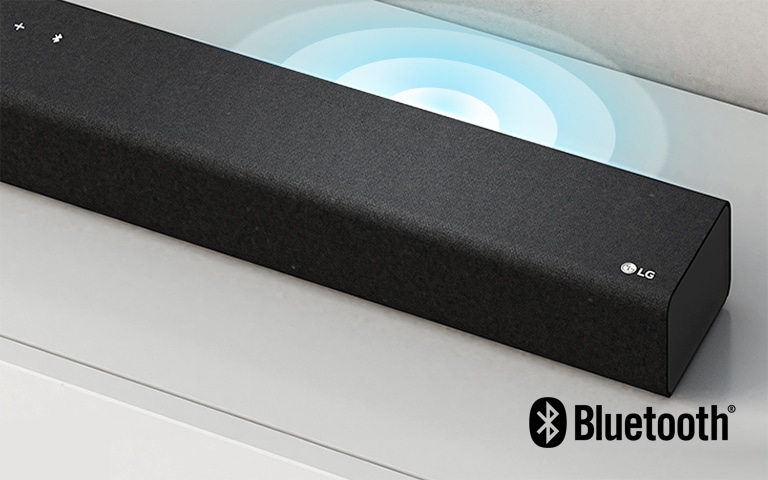 LG Sound Bar is on the white shelf. The Sound graphic coming out from the speaker. LG logo is shown on the right corner of the sound bar.