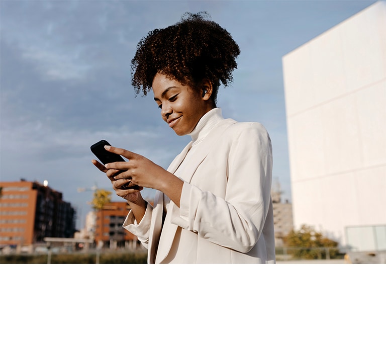 A woman is using her phone and listening to music with T90. The scene around her changes to a concert with sound waves showing the Dolby Atmos sound.