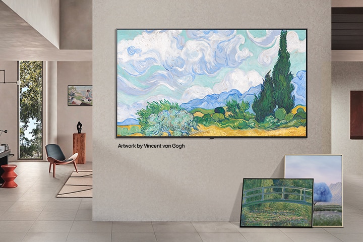 Interior of a sophisticated home. Lots of different artworks are displayed. On the center wall is an LG TV with popular artwork on the screen. The TV looks like a painting from a museum. 