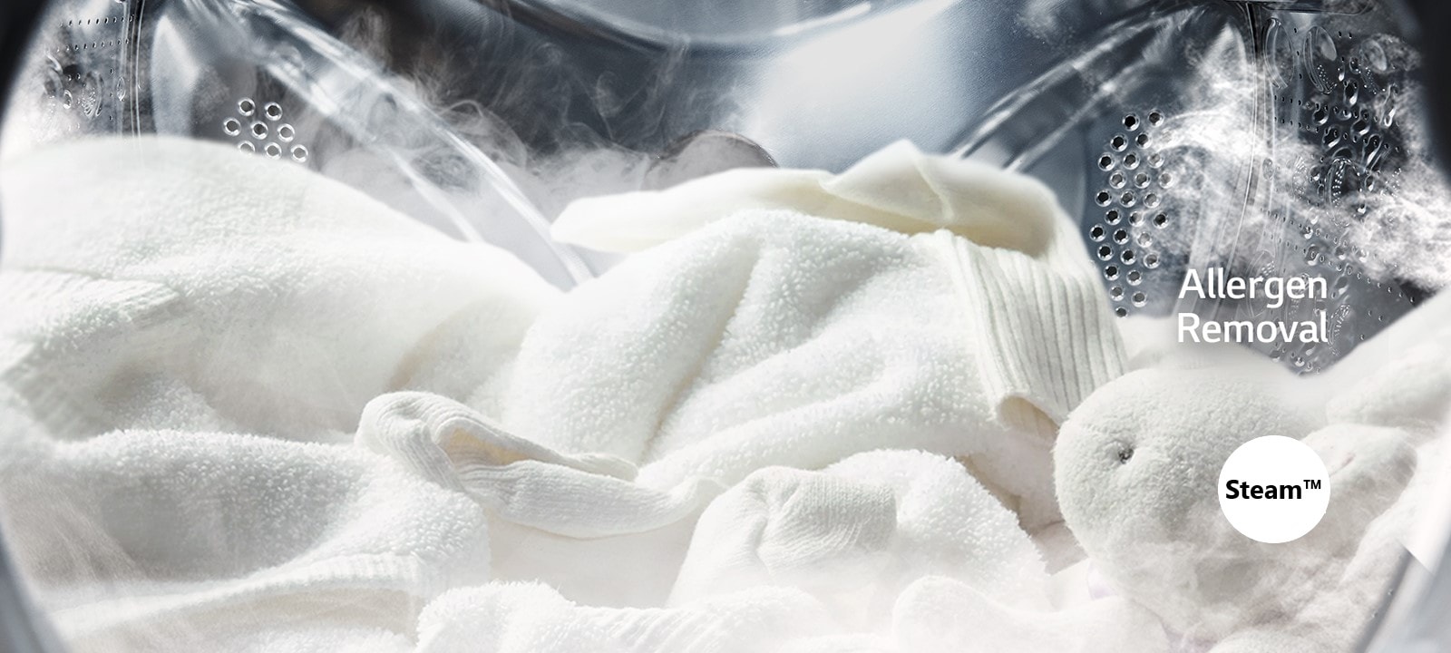 A soft white robe and stuffed animal are shown with steam in the drum of the washing machine.	