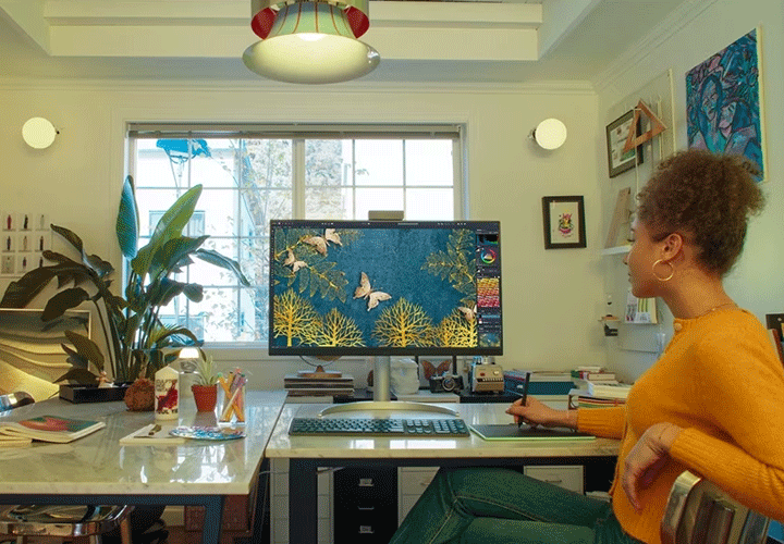 A woman uses a clean monitor in her home office