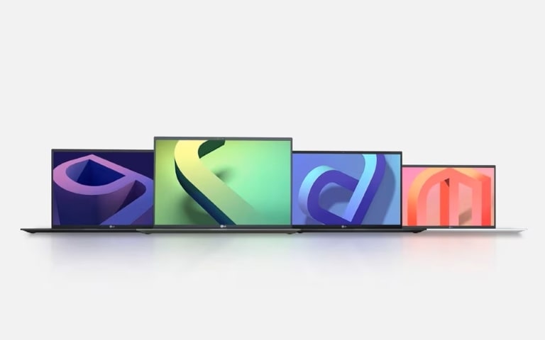 A row of four LG gram laptops, each displaying a different colourful abstract design on their screens, arranged on a white surface with a light background.