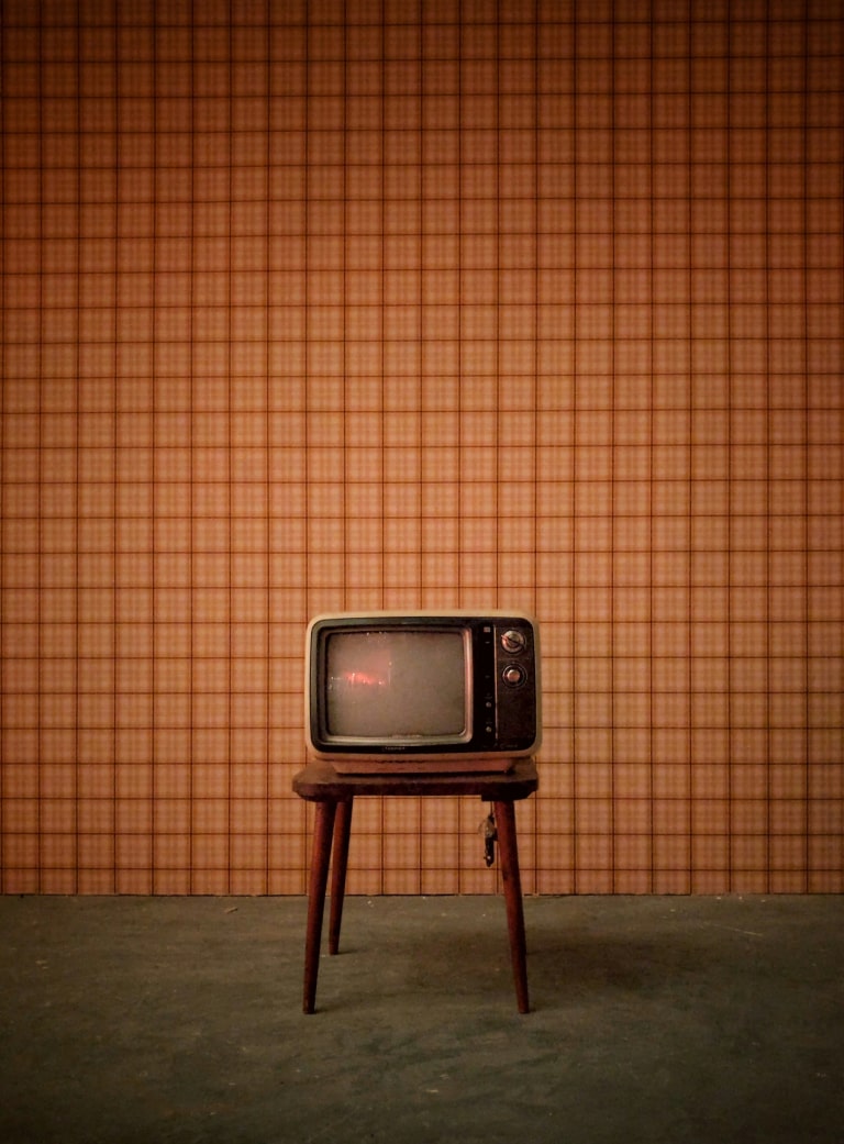 The evolution of television and entertainment, showing the transition from traditional, tangible TV sets to virtual, digital viewing experiences.