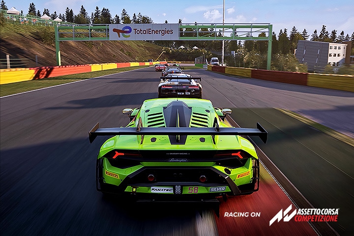 Image of a green car racing on a track.	