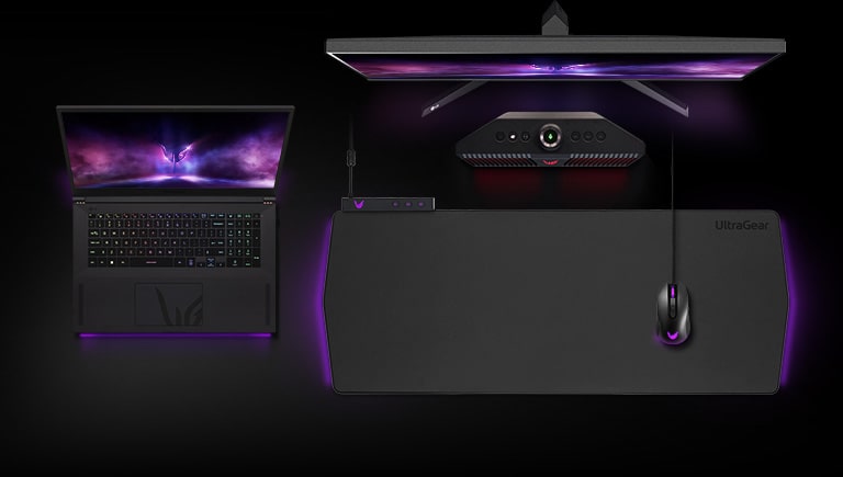 Top view of UltraGear ™ monitor, laptop, speakers, gaming pad, and mouse on black background.