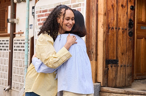 The host hugs the guest as they say goodbye.