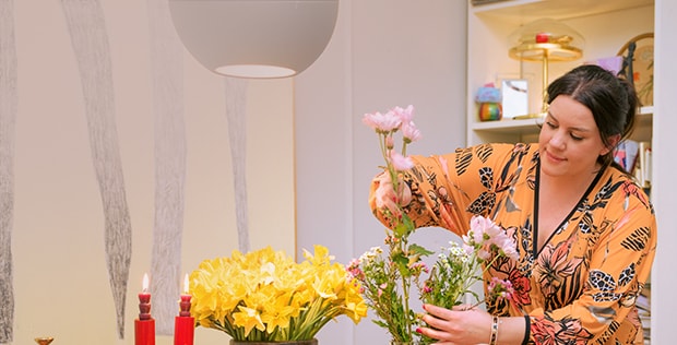 Image of a woman with a flower arrangement.