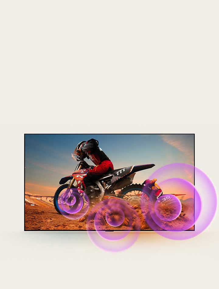 LG QNED TV depicts a man on a motorcycle with purple abstract circles coming out of the wheel to visualize sound emission.