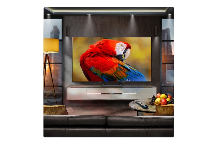 A family sits on a couch facing a LG QNED TV sitting above a TV stand with a little girl pointing to a screen depicting two dolphins. The title talks about how you can enjoy high resolution on a massive screen.