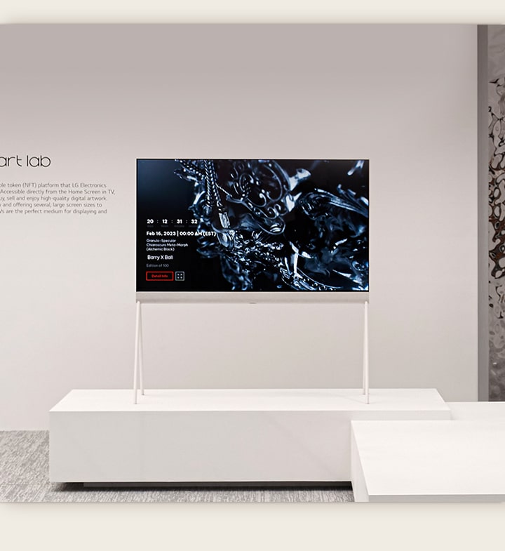 An image of Easel in a white room shows a digital artwork of a black sculpture on screen. A silver physical sculpture on the right-hand side of the TV shows a reflection of the room. 