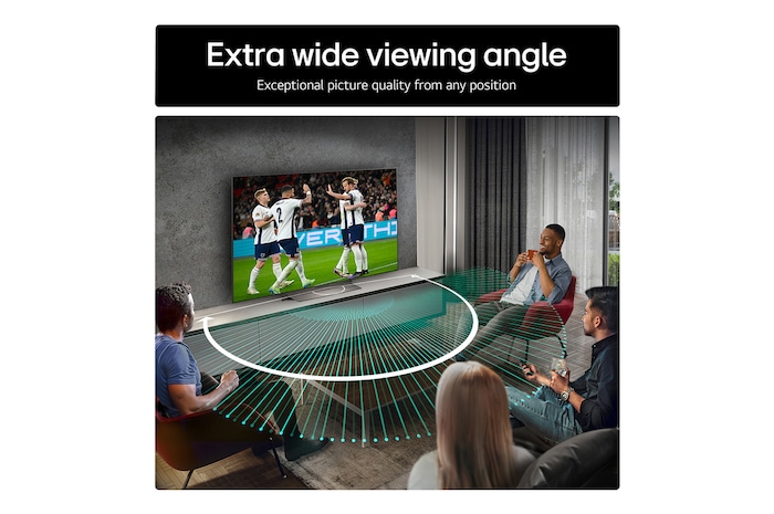 Living room space with a wall-mounted LG OLED TV. On the TV is a mountain range against a dark evening sky filled with stars. This scene is split in half. One side shows a duller, grayer version of the landscape labeled, Non Perfect Black display. On the other side is a more pleasing picture with a larger dynamic range of blacks and whites. 