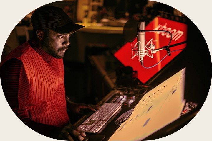 will.i.am is producing music at his desk
