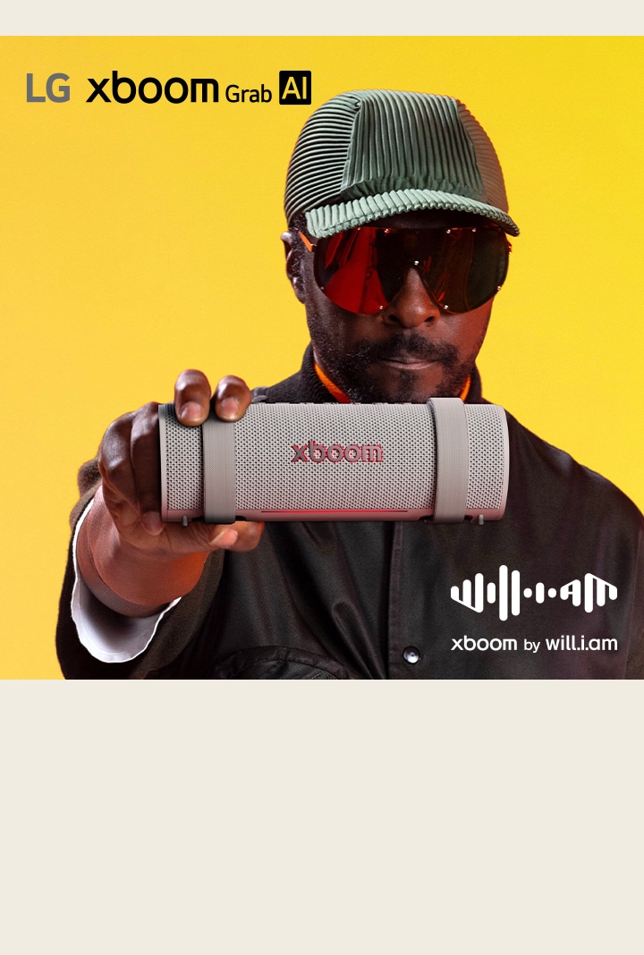 will.i.am in black outfit and sunglasses is holding xboom Grab to the front.