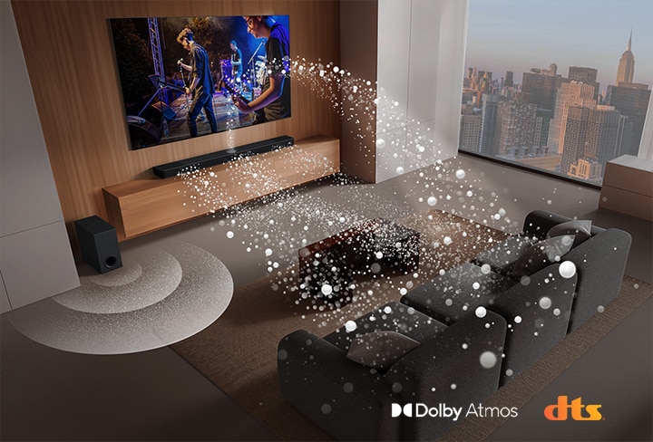 "Loa LG Soundbar, LG TV và loa siêu trầm đang phát một màn biểu diễn âm nhạc trong phòng khách của một tòa nhà chọc trời. Sóng âm thanh màu trắng được tạo thành từ những giọt nước phát ra từ loa soundbar vòng quanh ghế sofa. Loa siêu trầm đang tạo hiệu ứng âm thanh từ phía dưới. Logo Dolby Atmos Logo DTS"