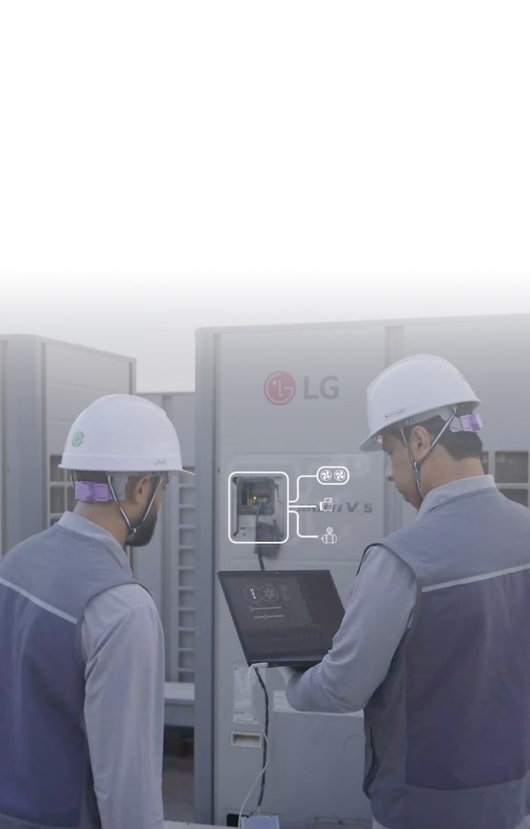 Technicians using a laptop to service LG MULTI V HVAC equipment, showing smart diagnostic interface during maintenance work.