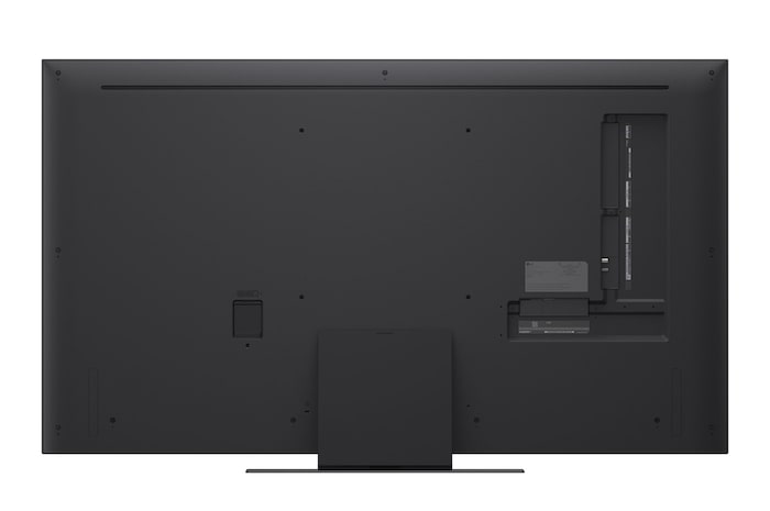 A girl and a dog are seated in front of a LG QNED TV mounted on a wall depicting three elephants walking outwards above a LG Soundbar. The title talks about how every action is more thrilling on a massive screen.