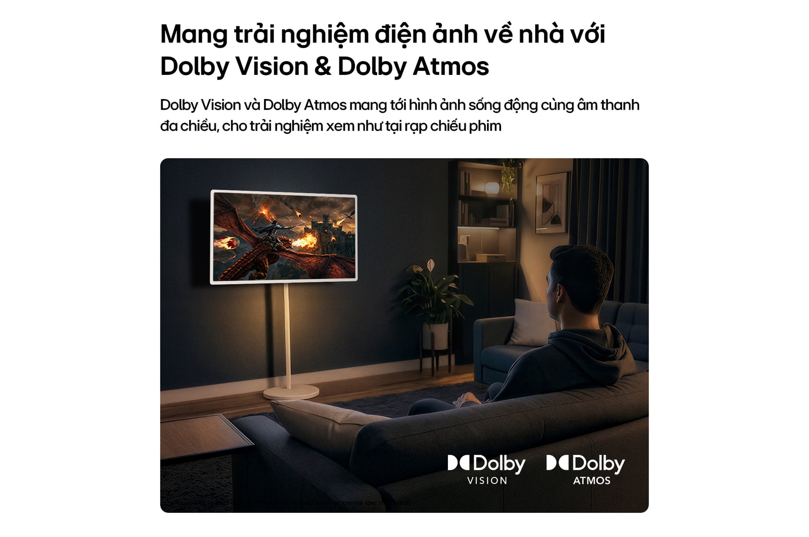 Màn hình Giải trí Di động LG StanbyME 2 Max LX6 với Dolby Vision và Dolby Atmos hiển thị cảnh một người đàn ông đang thưởng thức trận chiến giữa những con rồng trong không gian tối, nơi hình ảnh chân thực và âm thanh sống động tạo nên trải nghiệm điện ảnh ngay tại nhà.