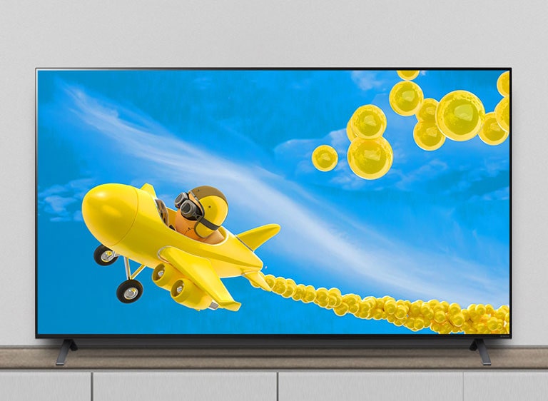 TV trên chân đỡ, và màn hình hiển thị hình ảnh động của một chiếc máy bay đang bay qua.