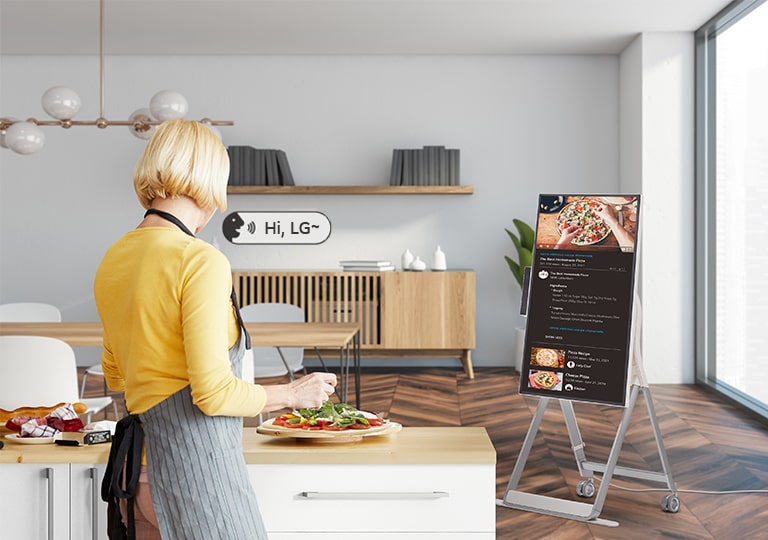 A woman is using voice commands to control the One:Quick Flex while cooking.