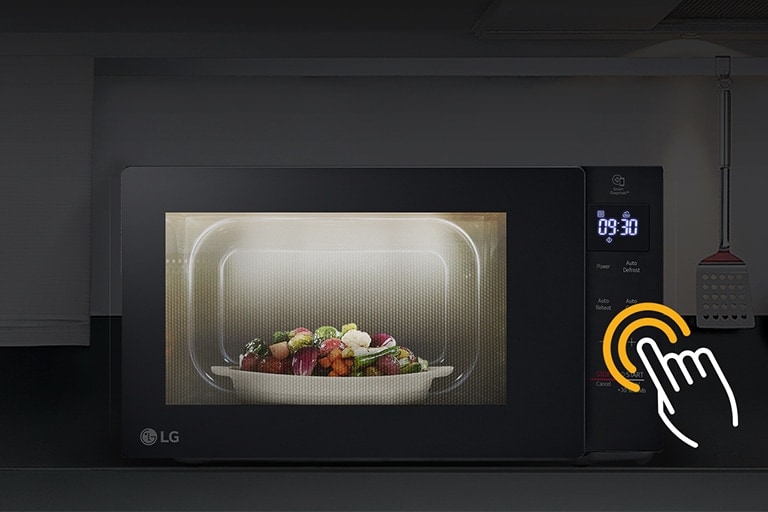 LG microwave with vegetable dish heating, control panel shows 03:30 with a hand icon indicating touch operation.
