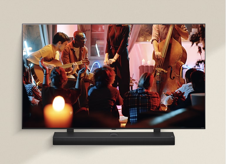 LG Remote is pointing towards a LG TV with LG Soundbar underneath. LG TV is showing the WOW Interface menu on the screen.