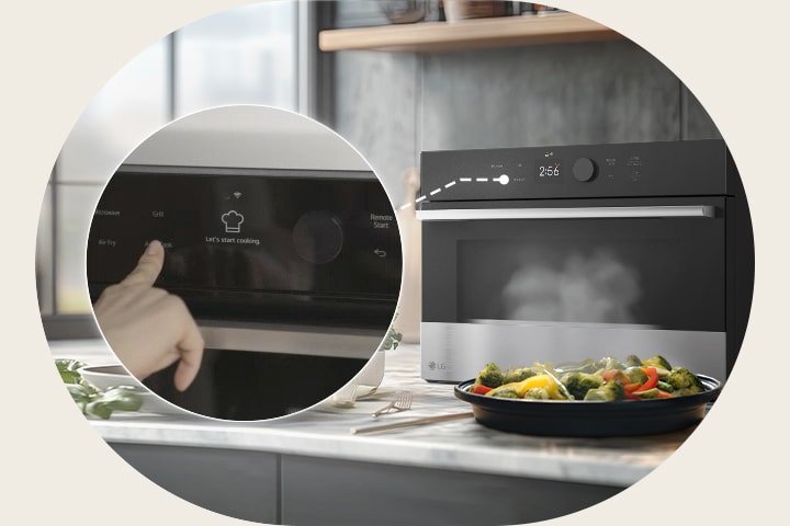 A person selects a cooking mode on the control panel while steam rises from steam-cooked vegetables in front of the SolarDOM™.