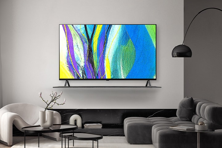 A TV is framed on a hotel wall’s shelf, and the TV screen shows works of art.