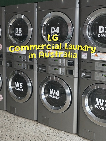 Commercial laundry room with multiple stainless steel washers lined up in a clean, modern space