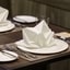 Restaurant table setting with neatly folded white napkins, highlighting professional hospitality