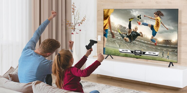 The father and daughter are playing games, and the game’s scene shown on the TV screen is realistically expressed.