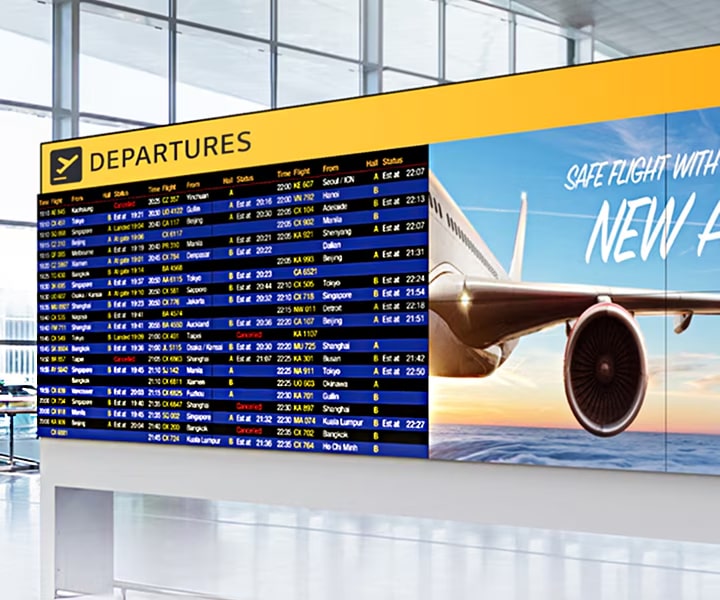 LG Video Wall at an airport departure lounge displaying synchronized flight information and airline promotions. Seamless LG Video Wall enhances passenger experience with vibrant visuals and reliable digital signage.