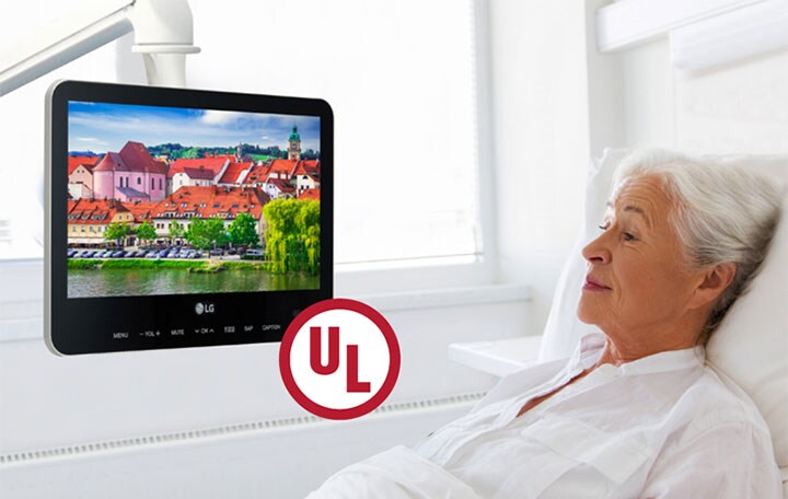 The patient is lying in the bed and watching the UL-listed TV.