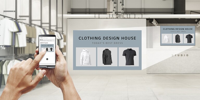 In a clothing store, a user is using the app to produce promotional content to display on the UM5K installed on the store’s wall.