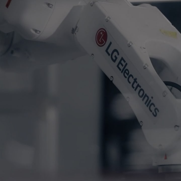 Close-up of an industrial robotic arm branded with LG Electronics, operating in a modern manufacturing environment
