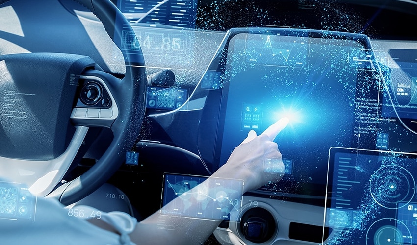 An image of a finger pointing the screen of a car