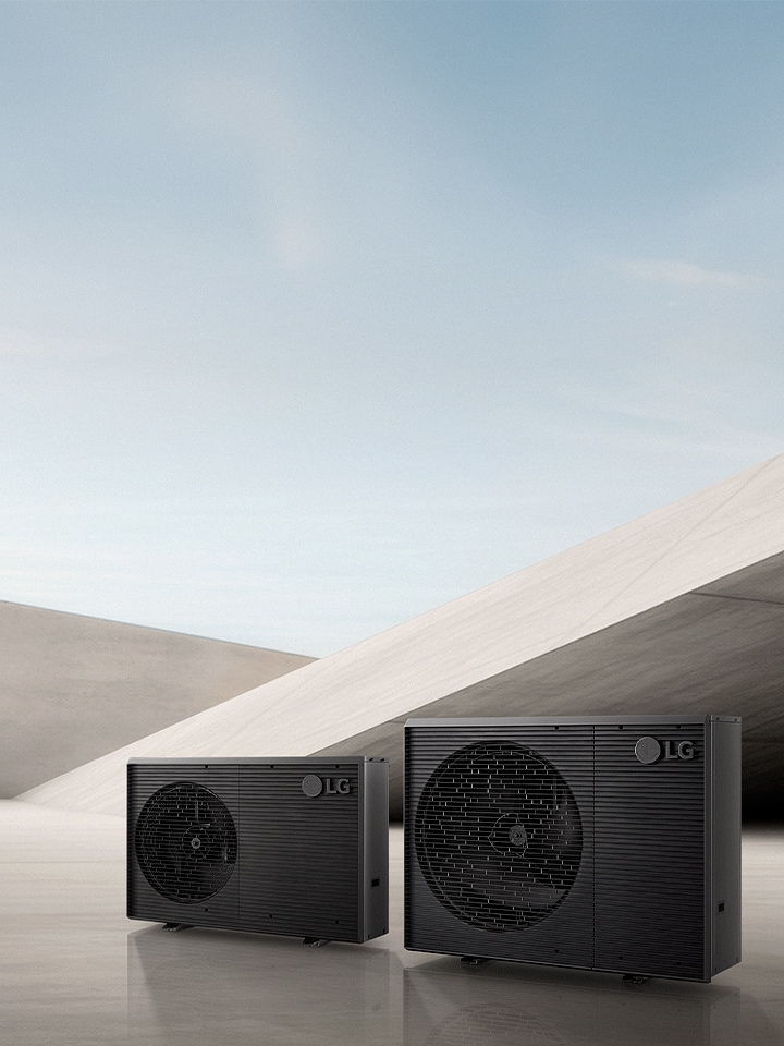 A image showing two LG Therma V R290 Monobloc S outdoor heat pump units in a minimalist concrete interior.	