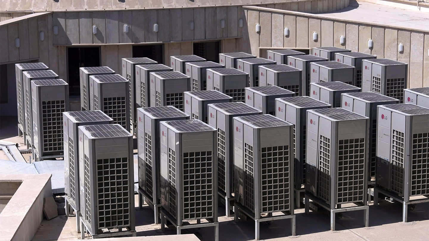Multiple LG Multi V VRF units installed on a rooftop, lined up.	 	 	
