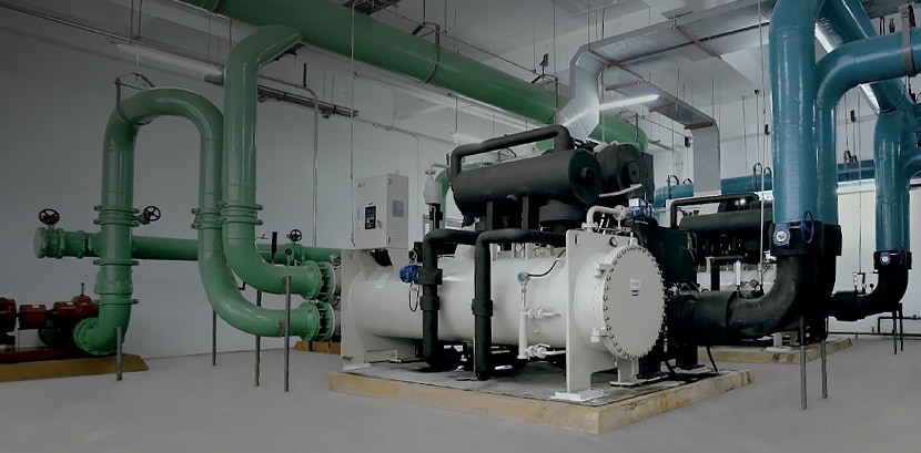 Large-scale industrial HVAC equipment and complex piping system inside a facility for optimized industrial operations.