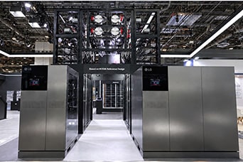 An LG data center exhibition booth featuring large metal cooling units and a central corridor with a structured ceiling.