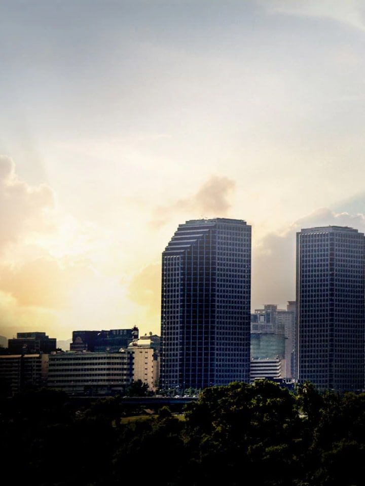 City skyline with tall buildings under evening sunlight promoting LG Business Solutions