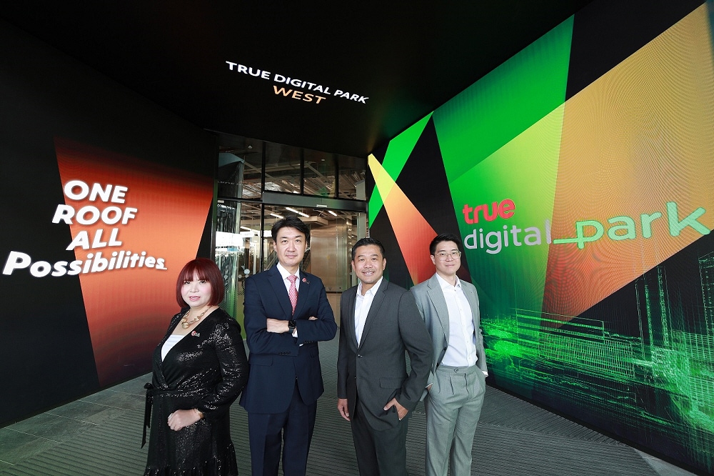 Executives from LG Electronics and True Digital Park standing before large LG LED signage highlighting the partnership’s “One Roof, All Possibilities” concept.