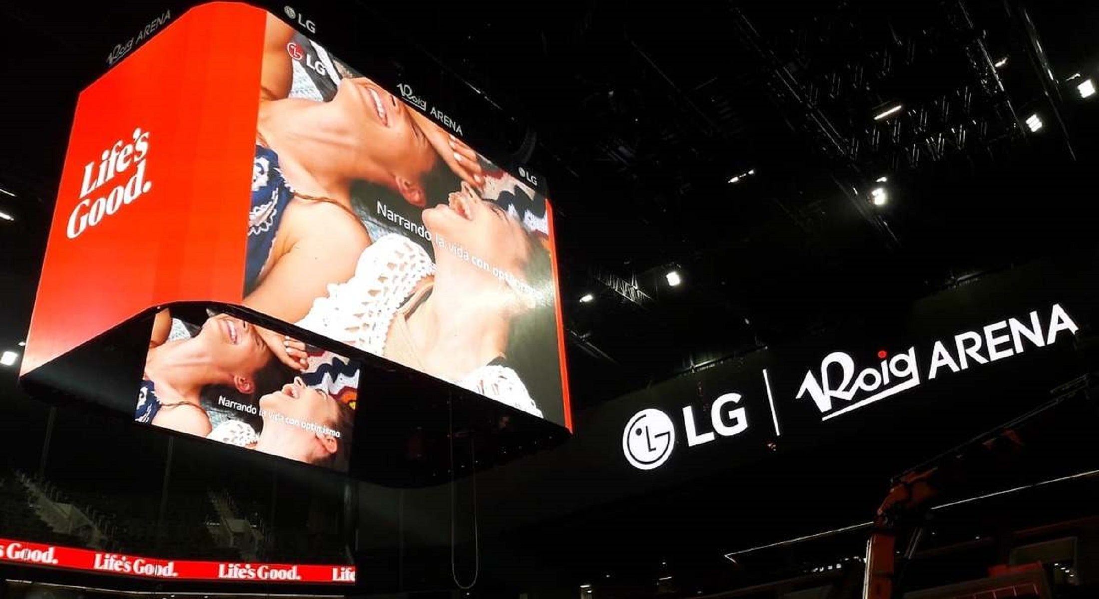 Massive central LED screen inside Roig Arena displaying LG branding and visuals, with surrounding arena signage showing LG and Roig Arena logos