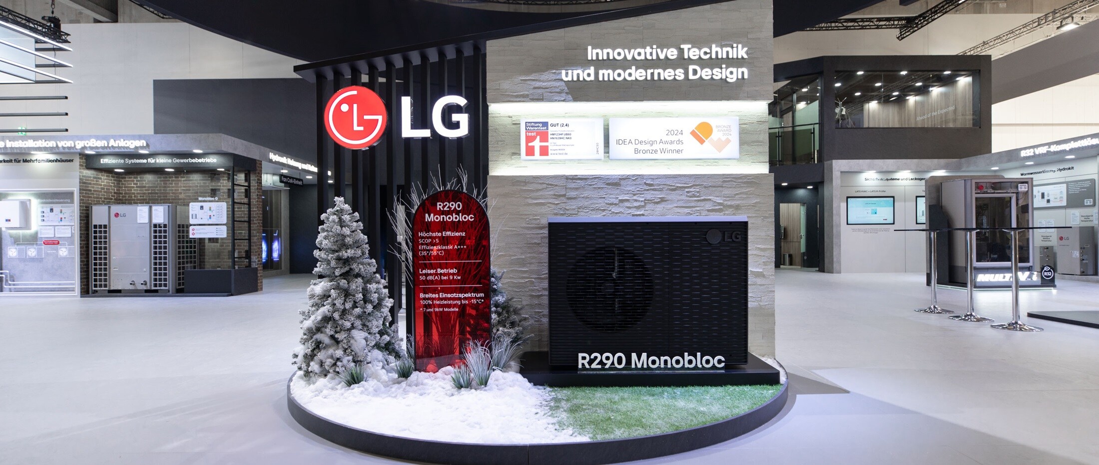 LG exhibition booth showcasing R290 Monobloc system with signage reading 'Innovative Technik und modernes Design' and decorated with artificial snow and a frosted tree
