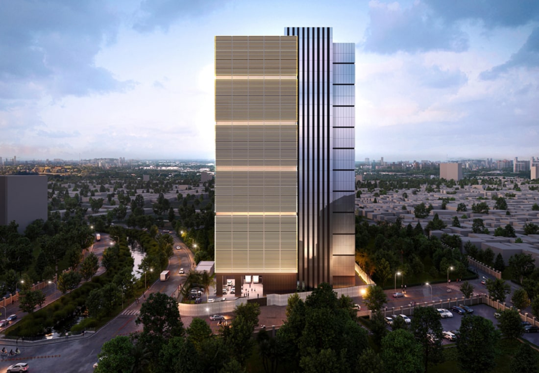 Modern high-rise building illuminated at dusk, surrounded by trees and urban infrastructure, with a cityscape in the background