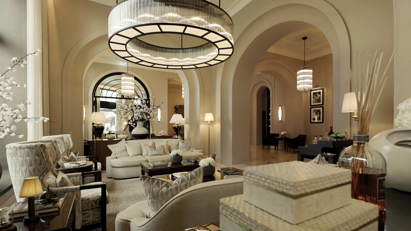 Elegant hotel lounge with arched ceilings, chandeliers, plush seating, and decorative coffee tables	