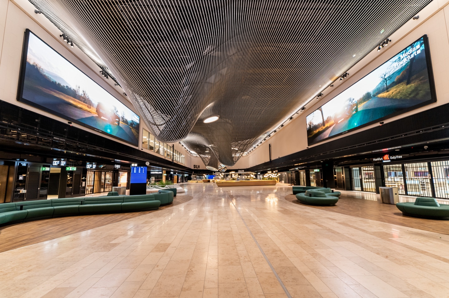 LG LED displays line both sides of the high-traffic central Marketplace at Frankfurt Airport's Terminal 3.